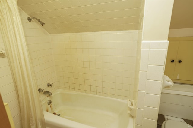 bathroom featuring shower / bath combo and toilet