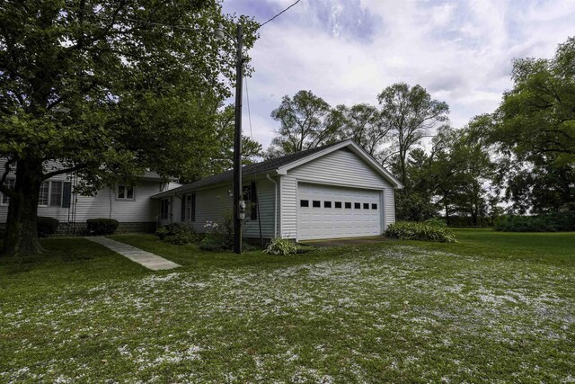 exterior space with a garage and a yard