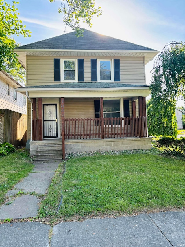 view of front facade featuring covered porch and a front lawn