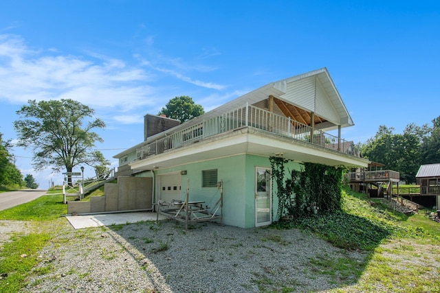 rear view of property featuring stucco siding