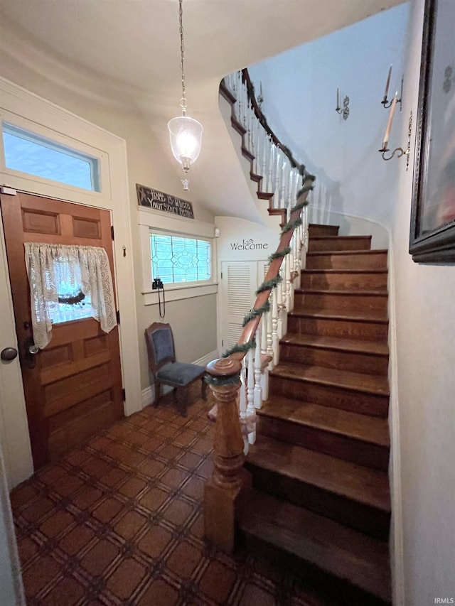 foyer entrance featuring dark tile patterned flooring