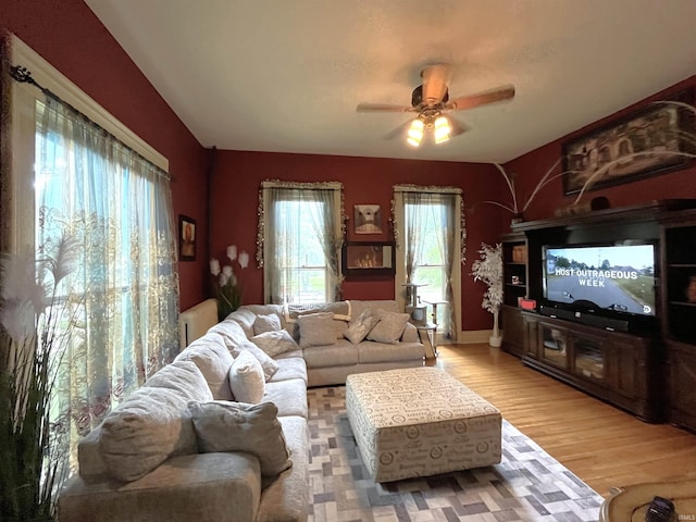 living room featuring radiator heating unit, wood-type flooring, and ceiling fan