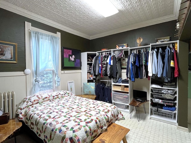 bedroom featuring crown molding, a closet, and radiator heating unit