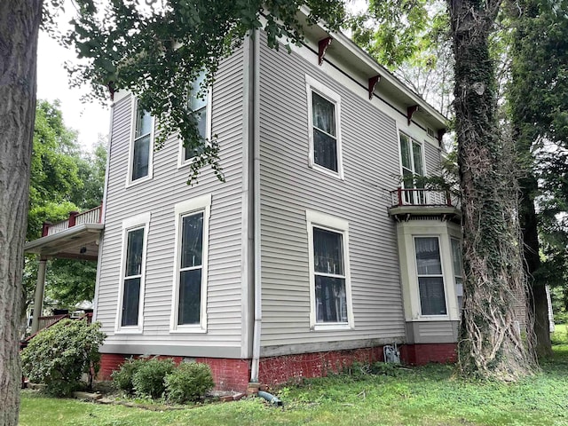 view of side of home with a lawn