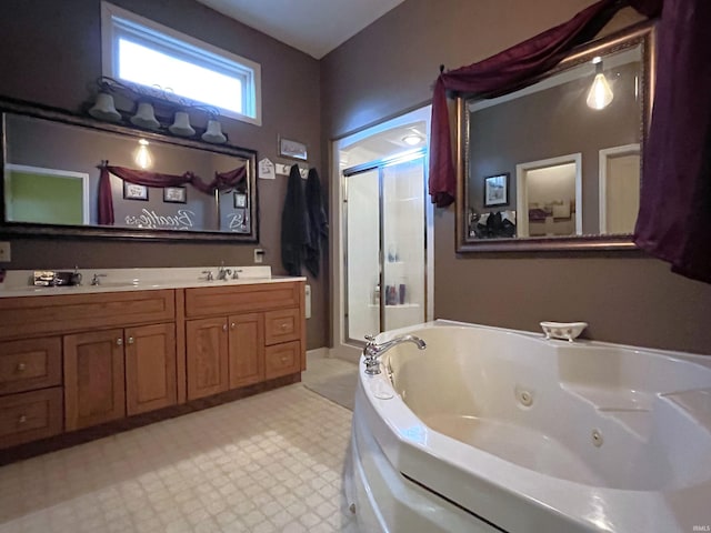 bathroom featuring dual vanity, shower with separate bathtub, and tile patterned flooring