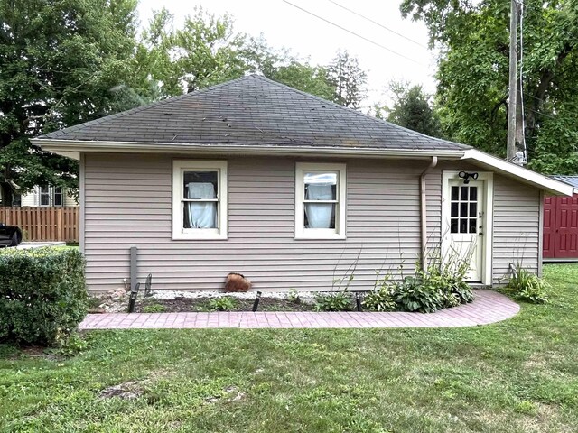 view of property exterior with a yard