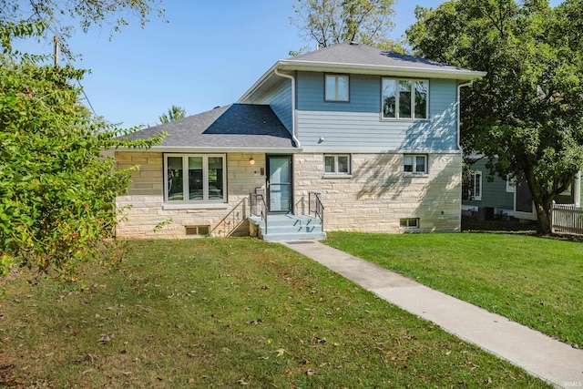 tri-level home with a front lawn