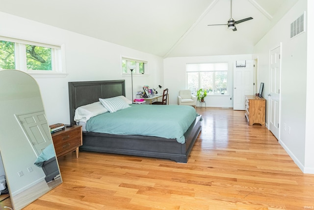 bedroom with light hardwood / wood-style flooring, multiple windows, ceiling fan, and high vaulted ceiling