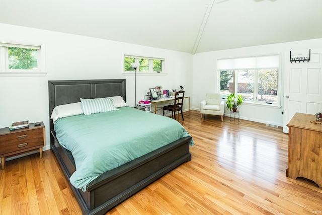 bedroom featuring lofted ceiling and hardwood / wood-style floors