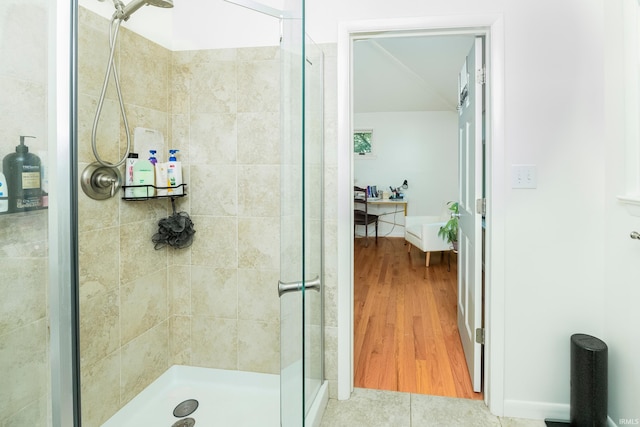 bathroom featuring walk in shower and hardwood / wood-style flooring