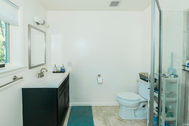 bathroom with vanity, toilet, and tile patterned floors