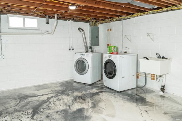 laundry room with sink, electric panel, and independent washer and dryer