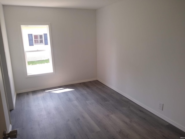 spare room featuring dark wood-type flooring