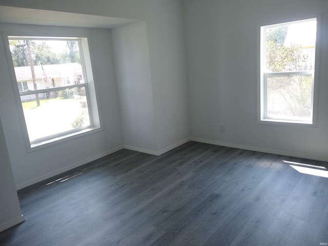 empty room with a healthy amount of sunlight and hardwood / wood-style floors