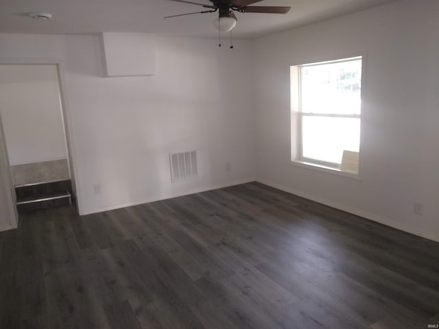 spare room with dark hardwood / wood-style floors and ceiling fan