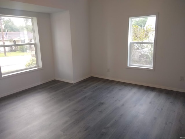 spare room featuring a wealth of natural light and hardwood / wood-style flooring