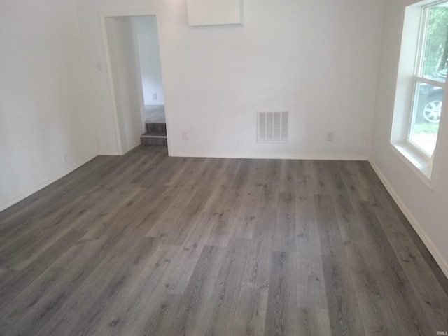 unfurnished room with a wealth of natural light and hardwood / wood-style floors