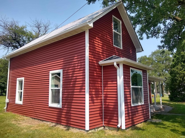 view of home's exterior with a yard