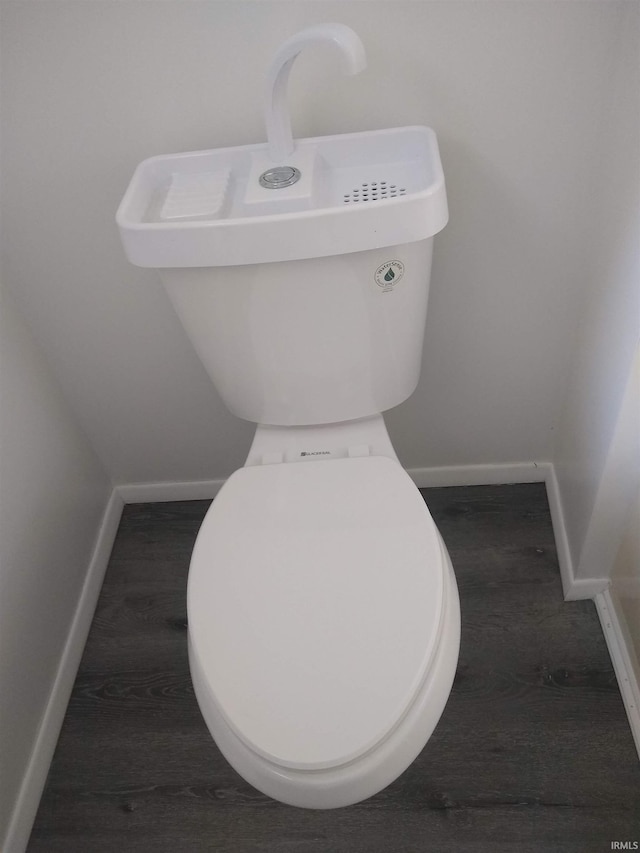 interior space with hardwood / wood-style flooring and toilet