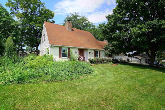 new england style home with a front yard