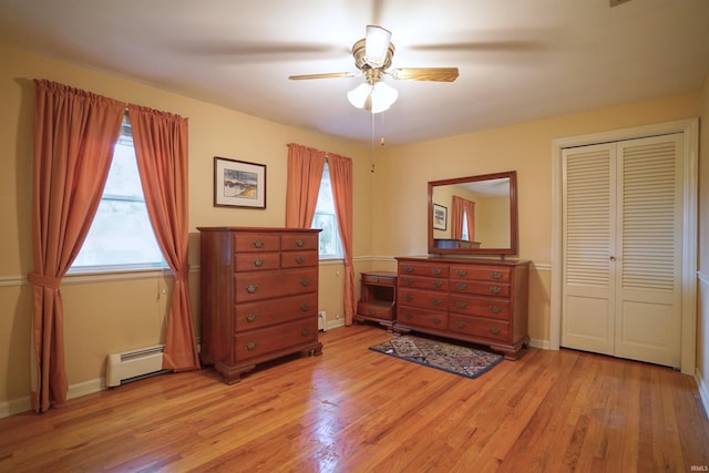 bedroom with light hardwood / wood-style floors, ceiling fan, and multiple windows