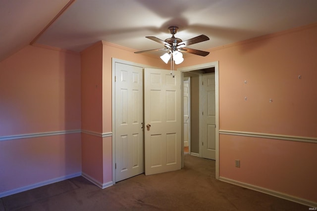 unfurnished bedroom with a closet, ceiling fan, carpet floors, and crown molding