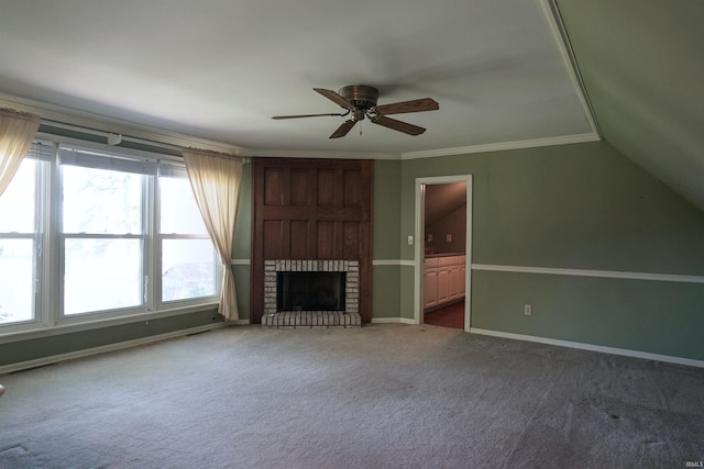 unfurnished living room featuring a brick fireplace, ceiling fan, plenty of natural light, and carpet flooring