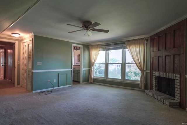 unfurnished living room featuring ornamental molding, ceiling fan, carpet flooring, and a fireplace