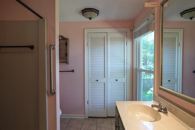 bathroom with tile patterned flooring, vanity, and toilet