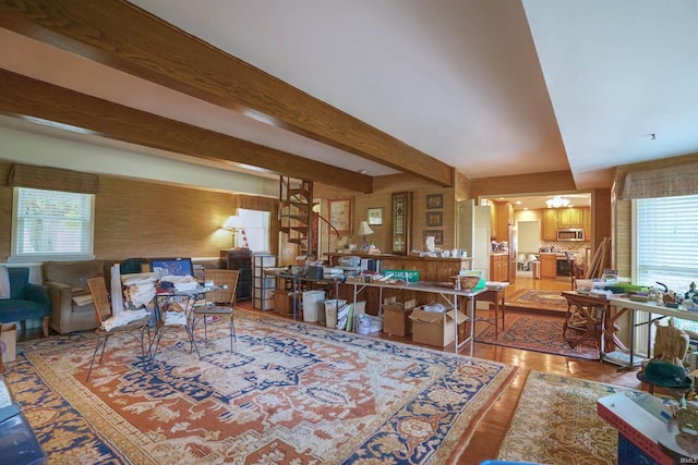 living room featuring beamed ceiling and hardwood / wood-style flooring