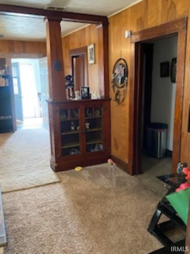 interior space featuring carpet floors and wooden walls