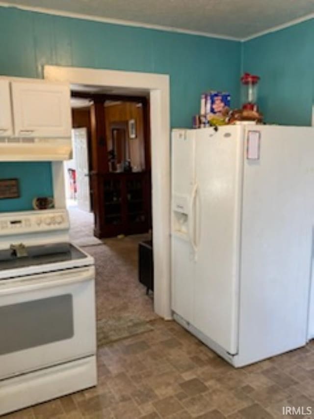 kitchen with tile patterned floors, extractor fan, and white appliances