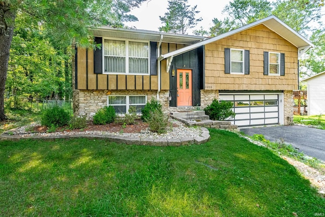 raised ranch with a garage and a front yard