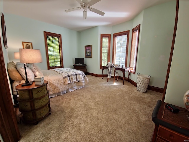 carpeted bedroom featuring a ceiling fan and baseboards