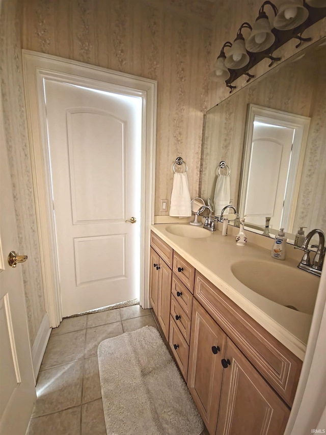 full bath featuring tile patterned floors, a sink, and double vanity