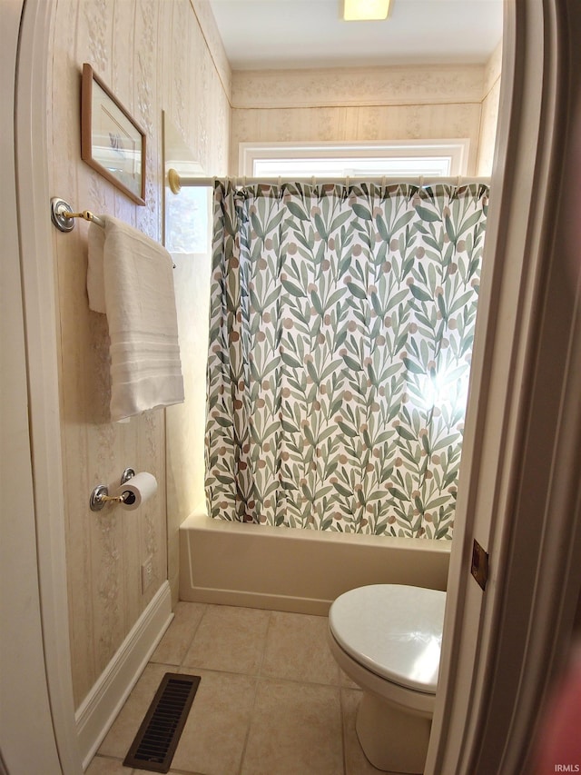 bathroom with toilet, shower / bathtub combination with curtain, visible vents, and tile patterned floors