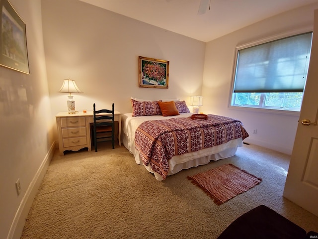 bedroom featuring baseboards, a ceiling fan, and light colored carpet