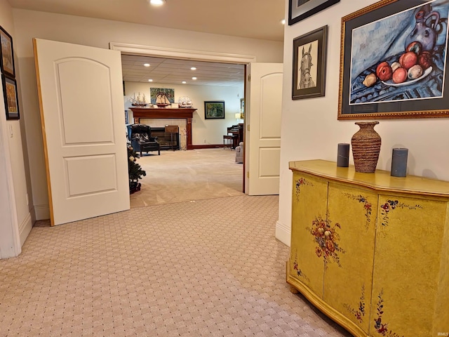 corridor featuring baseboards, light colored carpet, and recessed lighting