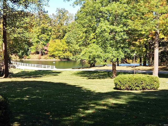 view of yard with a water view and fence