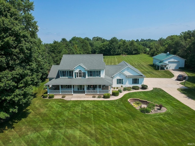 view of front of home featuring a garage, an outdoor structure, and a front lawn