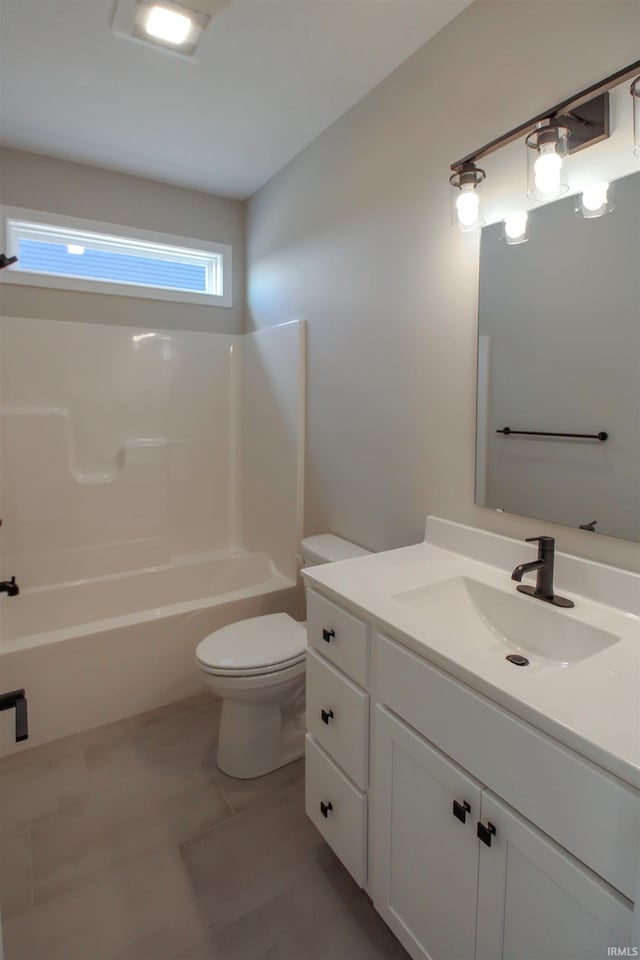 full bathroom featuring tile patterned flooring, vanity,  shower combination, and toilet