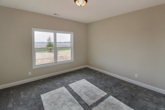 empty room featuring dark colored carpet