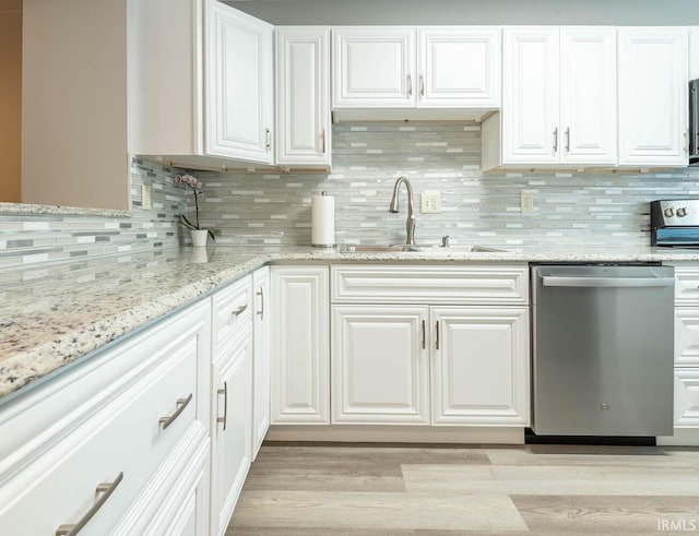 kitchen featuring white cabinetry, tasteful backsplash, sink, dishwasher, and light hardwood / wood-style floors