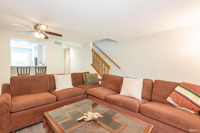 living room featuring hardwood / wood-style floors and ceiling fan