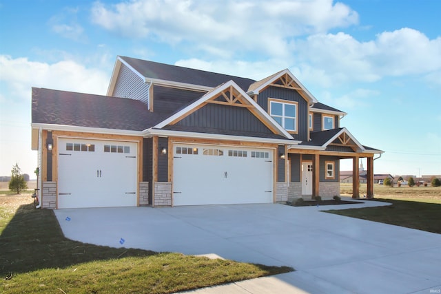 craftsman house with a front yard and a garage