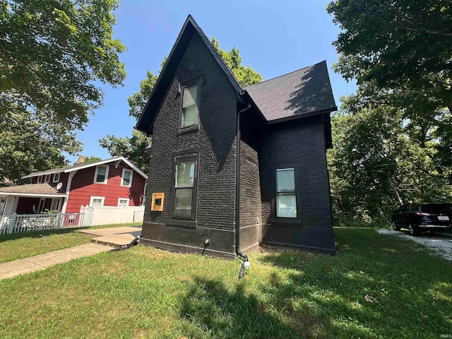 view of home's exterior with a lawn