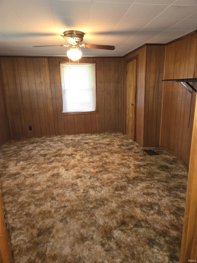 unfurnished room featuring carpet and ceiling fan