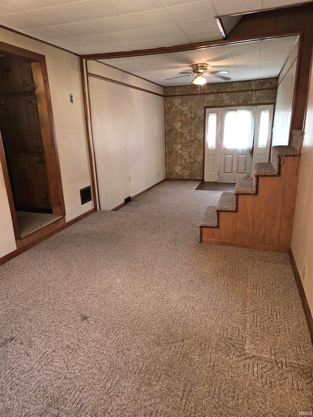 basement with carpet floors and ceiling fan