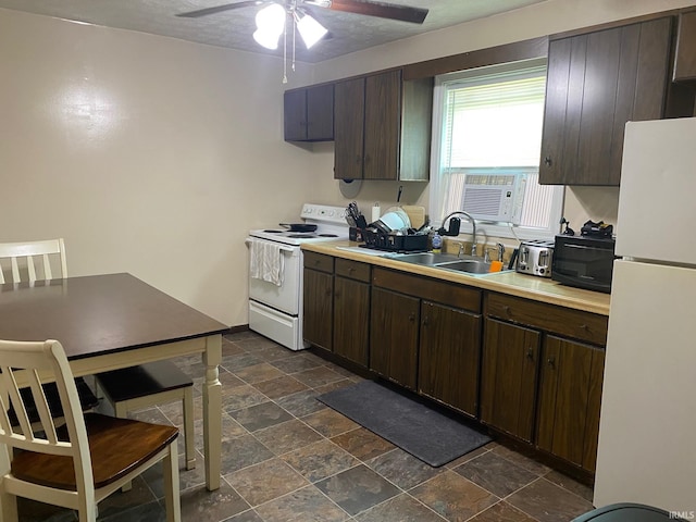 kitchen featuring dark brown cabinetry, sink, white appliances, a textured ceiling, and ceiling fan