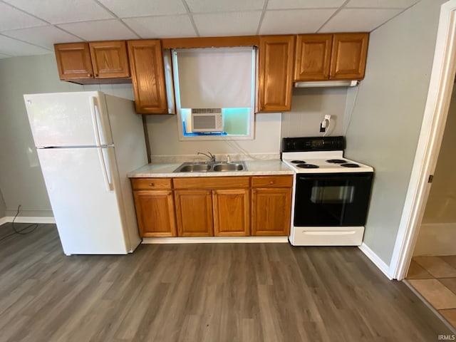 kitchen featuring sink, white refrigerator, dark hardwood / wood-style floors, range with electric cooktop, and a drop ceiling